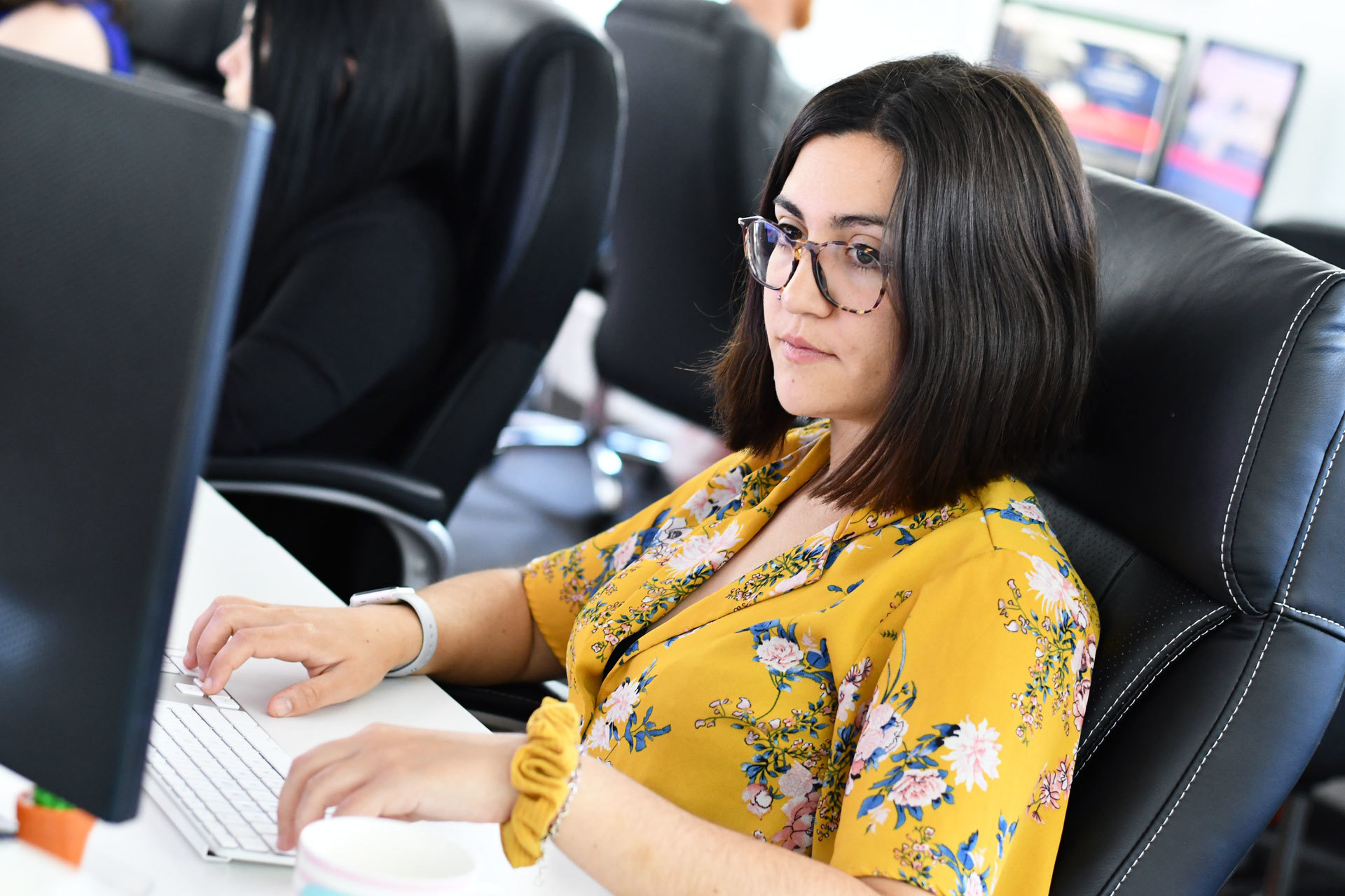 A website designer sat at her desk